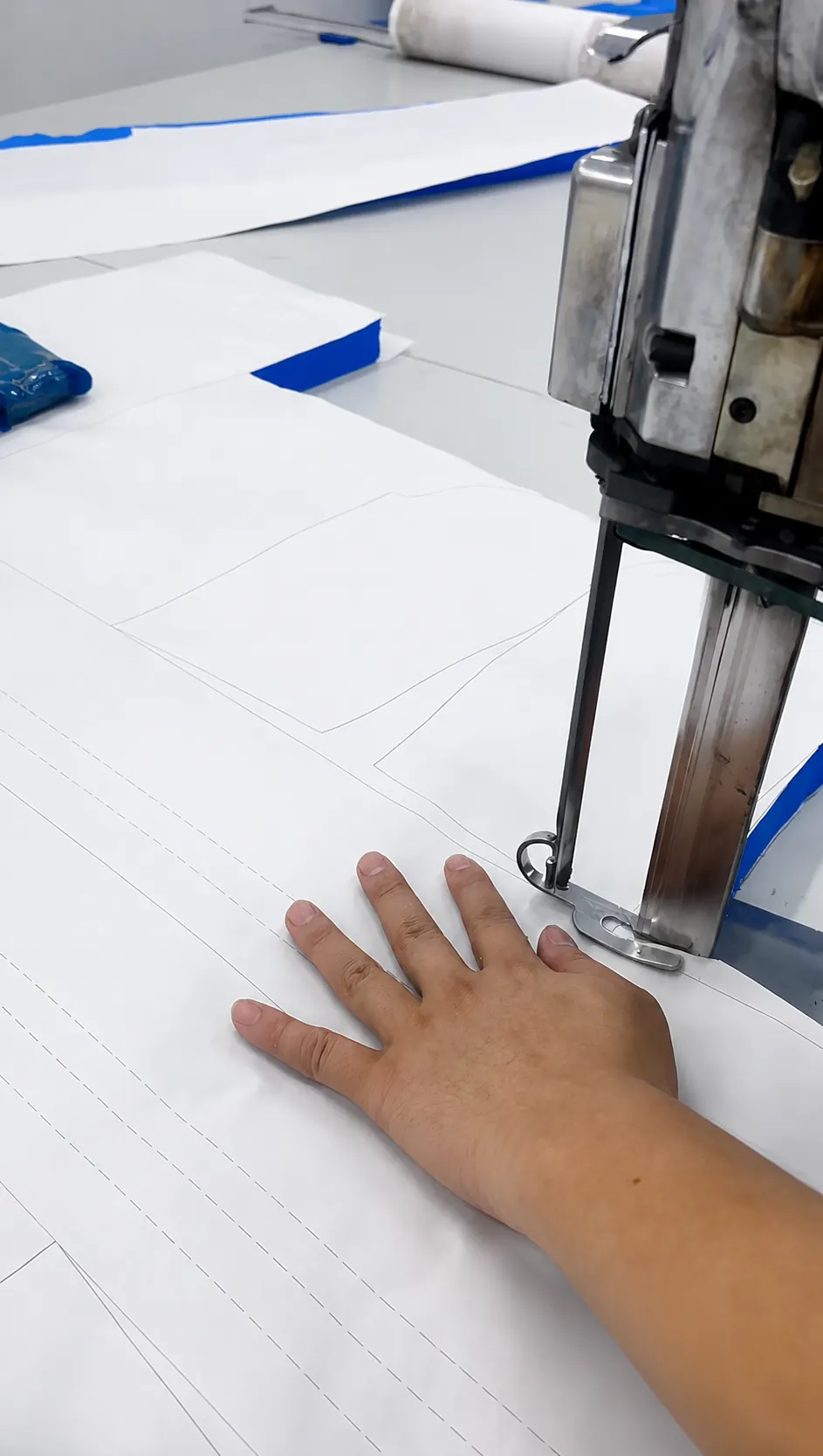 Bulk fabric layers being cut into approved garment components