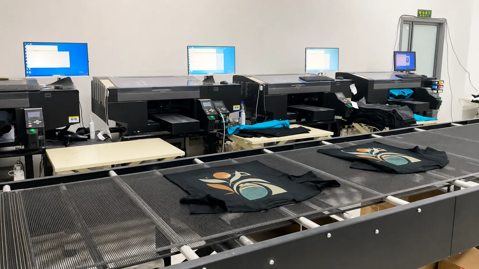 Direct-to-garment printing workspace with decorated T-shirts